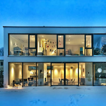 Contemporary home at night with warm indoor lighting, illustrating best lumens and kelvins for different rooms