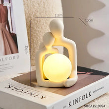 Abstract modern decor table lamp with a couple figurine and soft lighting, perfect for intimate spaces.