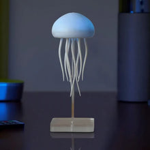 A soothing blue LED-lit AquaGlow Jellyfish Lamp placed in a dimly lit room.