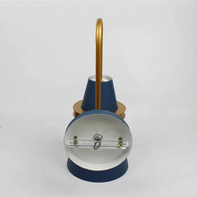 Back view of a blue and gold wall light with mounting hardware, ready for installation.