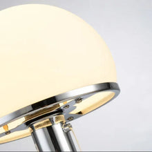 Detailed view of the opal glass lampshade with chrome accents of a Bauhaus table lamp.