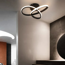 Sophisticated black LED ceiling lamp providing warm neutral white light in a modern hallway with artistic decor.