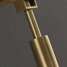 Close-up of the brass wall light's metal detailing, emphasizing its high-quality build.