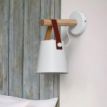 White Celora Wooden Wall Light mounted in a serene bedroom with rustic decor