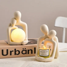 Ceramic decorative table lamp with a unique couple sculpture holding a luminous sphere, ideal for home and office decor.