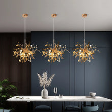 Three modern gold chandeliers hanging in a contemporary dining area, providing stylish and functional lighting for elegant dining settings.