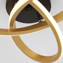 Close-up of the gold APTEL LED ceiling lamp, showcasing its sleek, curved design and energy-efficient LED strips.