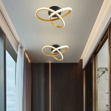 Two gold LED ceiling lamps installed in a modern hallway, adding a sleek and stylish lighting element.