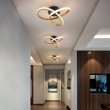 Three gold LED ceiling lights installed in a stylish hallway, creating a uniform and energy-efficient lighting design.