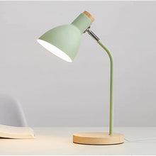 Minimalist Lesko Desk Lamp in soft green, featuring a wooden base and an adjustable metal shade for focused lighting.