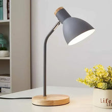 Modern grey Lesko Desk Lamp with a flexible neck and wooden base, ideal for home offices and study areas.