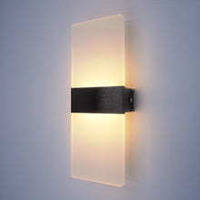 Black finish LumoGlow Warm LED Wall Lamp mounted on a white wall, providing sleek design and warm illumination.