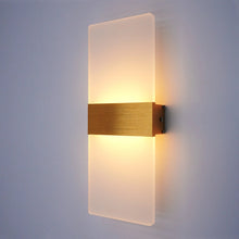 Gold finish LumoGlow Warm LED Wall Lamp mounted on a white wall, emitting soft warm light.