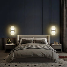 LumoGlow Warm LED Wall Lamps installed in a modern bedroom on both sides of a bed, creating a cozy ambiance.