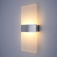 Silver finish LumoGlow Warm LED Wall Lamp mounted on a white wall, offering soft and warm lighting.