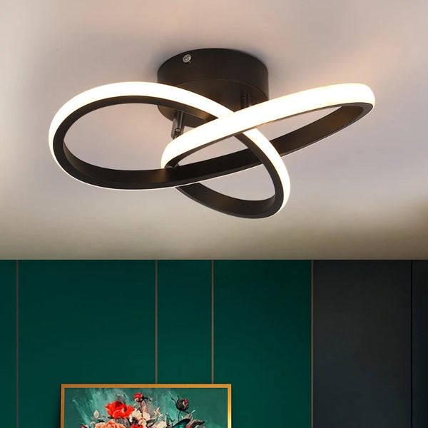 Stylish black LED ceiling light with intertwined LED loops, perfect for modern interior lighting in a dark green room.