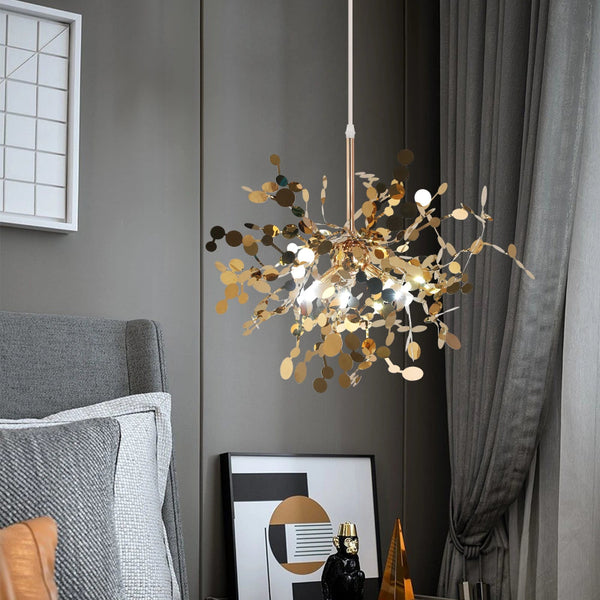 Modern gold chandelier pendant light hanging beside a stylish bedroom nightstand, enhancing the cozy ambiance with warm illumination.