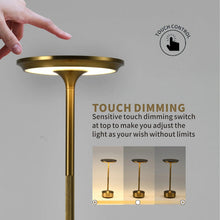 A gold Metal Glow Lamp with a hand touching the top for dimming control.