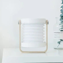 TrailOrb 4-in-1 Folding Lamp in its compact lantern shape, standing on a minimalist white table.