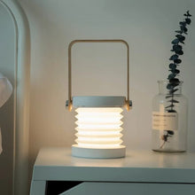 TrailOrb 4-in-1 Folding Lamp in nightlight mode, placed on a bedside table, creating a cozy atmosphere.