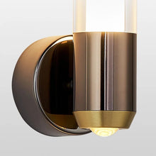 Detailed view of Luxor wall lamp’s brushed black and gold finish with downward acrylic diffuser.