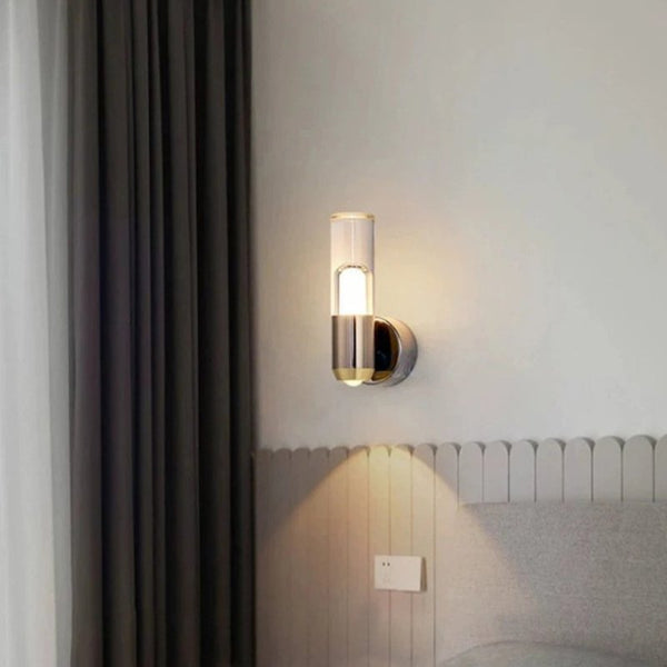 Side view of wall-mounted Luxor light illuminating a bedroom corner with curtains and neutral tones.