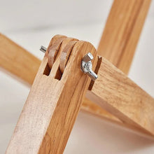 A close-up view of the wooden joints and metal screws of the WoodFlex Table Lamp.