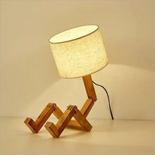 The WoodFlex Table Lamp glowing warmly, highlighting its natural wooden frame.